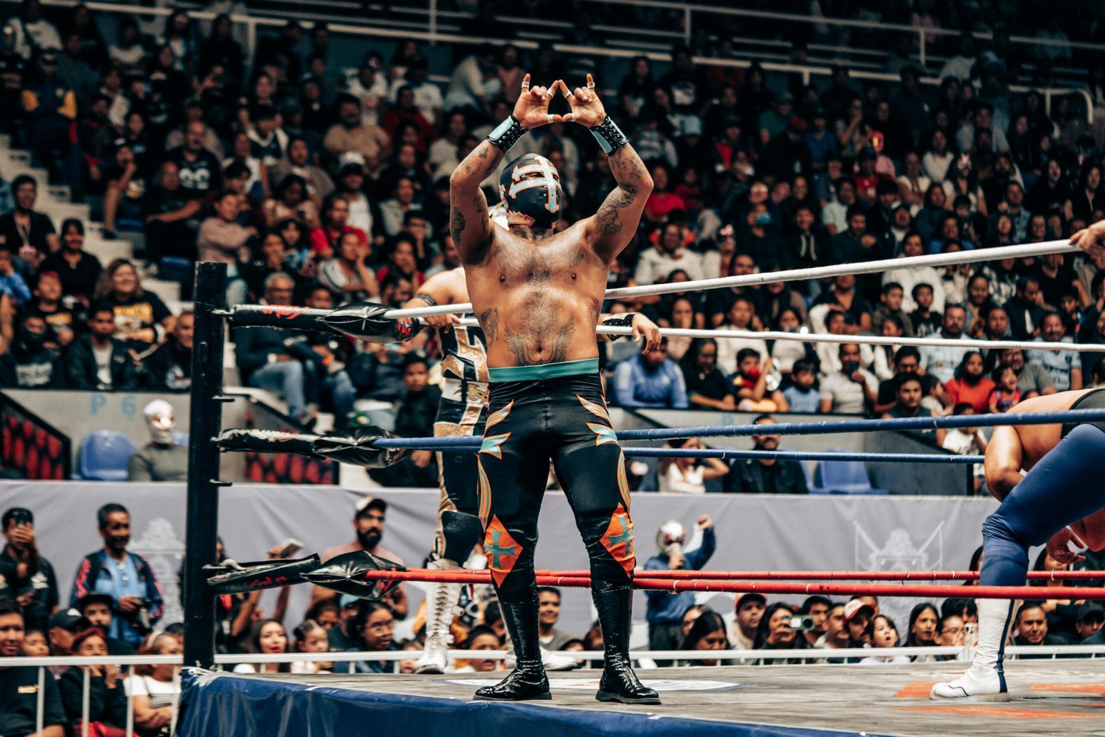 Vibrant lucha libre wrestling match in Santiago de Querétaro arena with masked wrestlers and enthusiastic crowd.